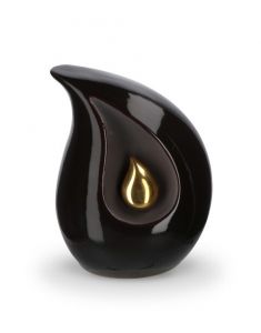 Teardrop cremation urn for ashes made of black ceramic with small gold-coloured teardrop