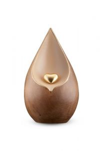 Teardrop cremation urn for ashes with gold-coloured heart made of double-stained limewood